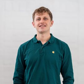 A man wearing a green polo shirt