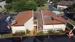 An aerial view of a building being cleaned by a cleaning company.