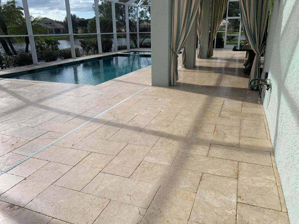 A large patio with a swimming pool in the background.