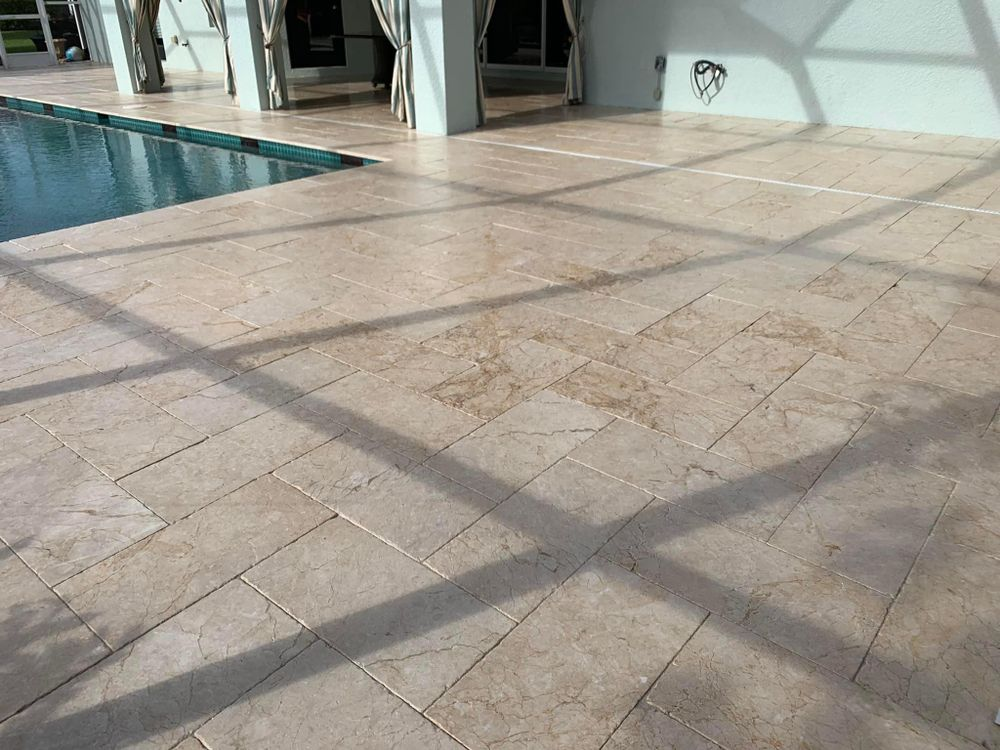 A tiled floor next to a swimming pool in a house.