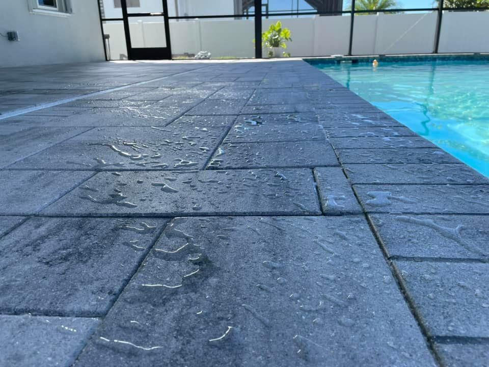 A swimming pool with a tiled floor next to it.
