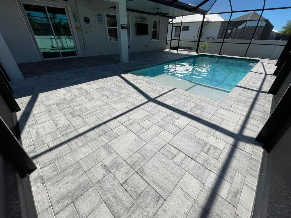 There is a large swimming pool in the backyard of a house.