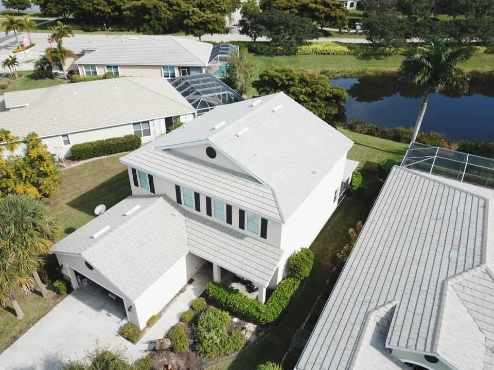 An aerial view of a house with a white roof