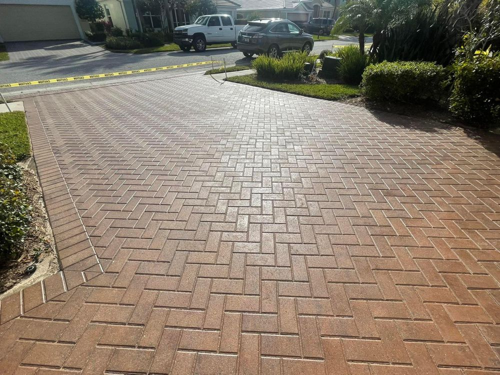 A brick driveway with a truck parked in it