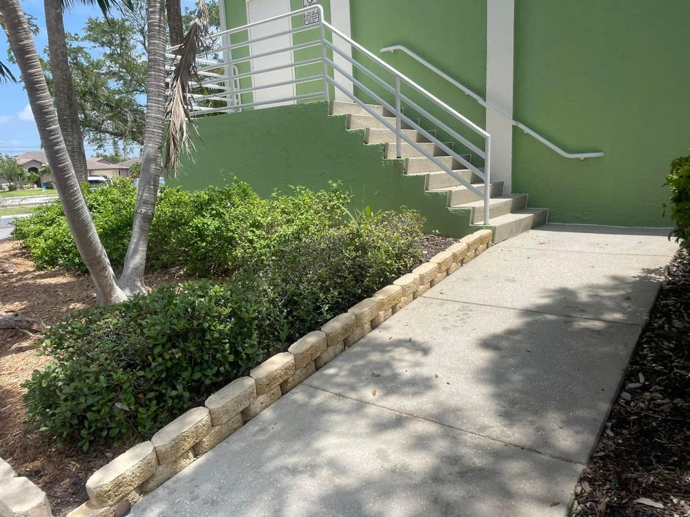 A ramp leading up to a green building with stairs