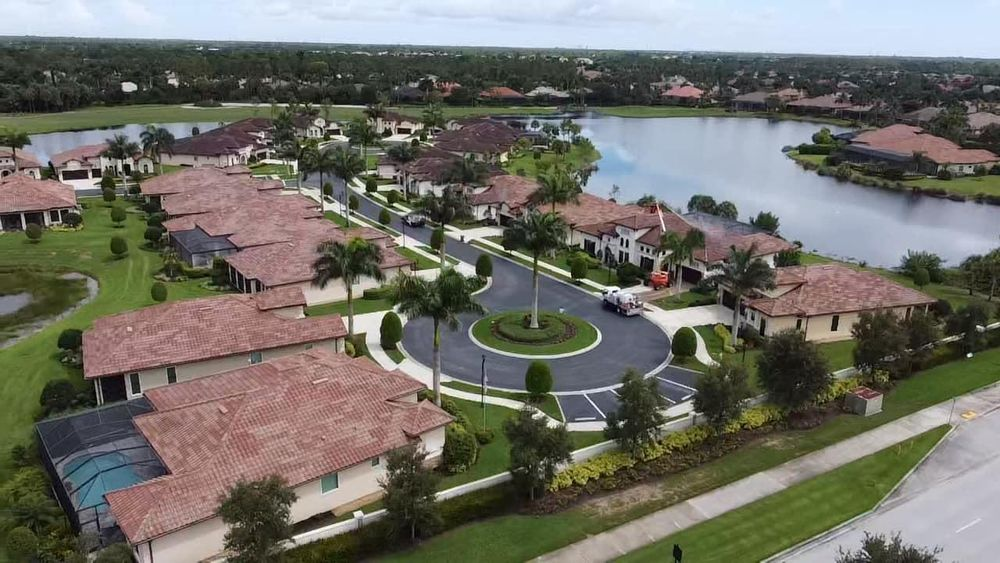 An aerial view of a residential area with a lake in the background.