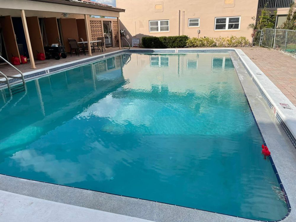 A large swimming pool is in front of a building.