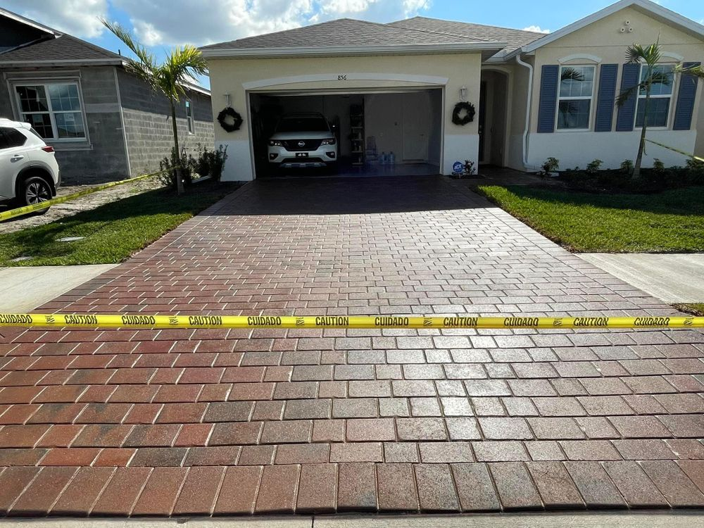A car is parked in a driveway in front of a house.