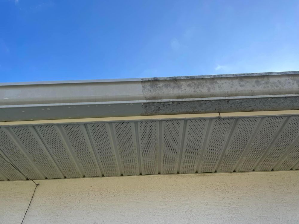 A before and after picture of a gutter on a house.