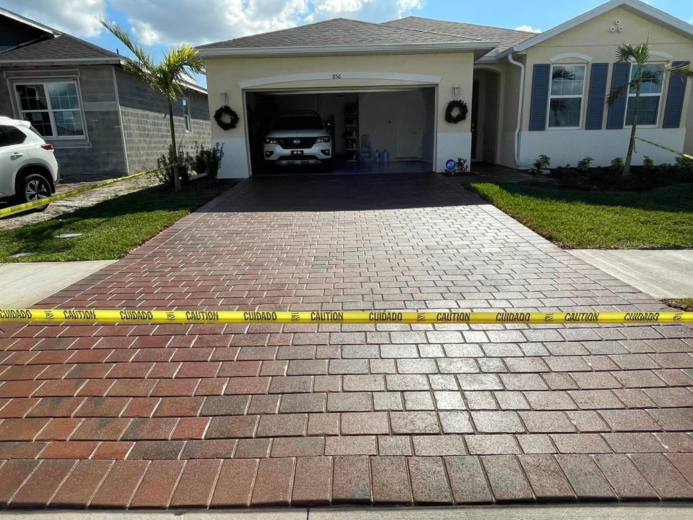 A car is parked in a driveway in front of a house.