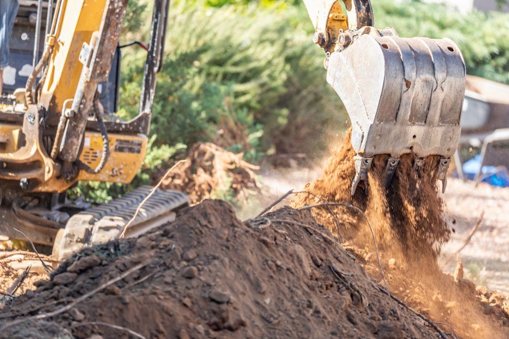 A bulldozer is digging a hole in the ground at a construction site.