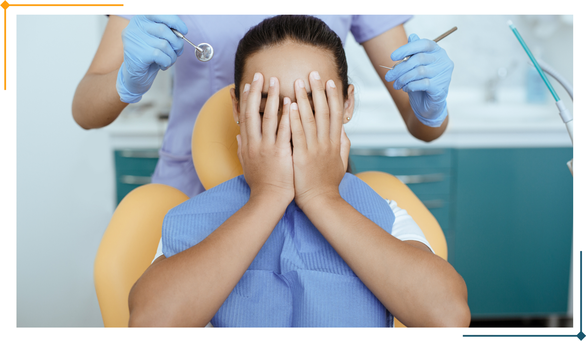 Person covering face in dentist chair, dentist holding tools, dental office setting.