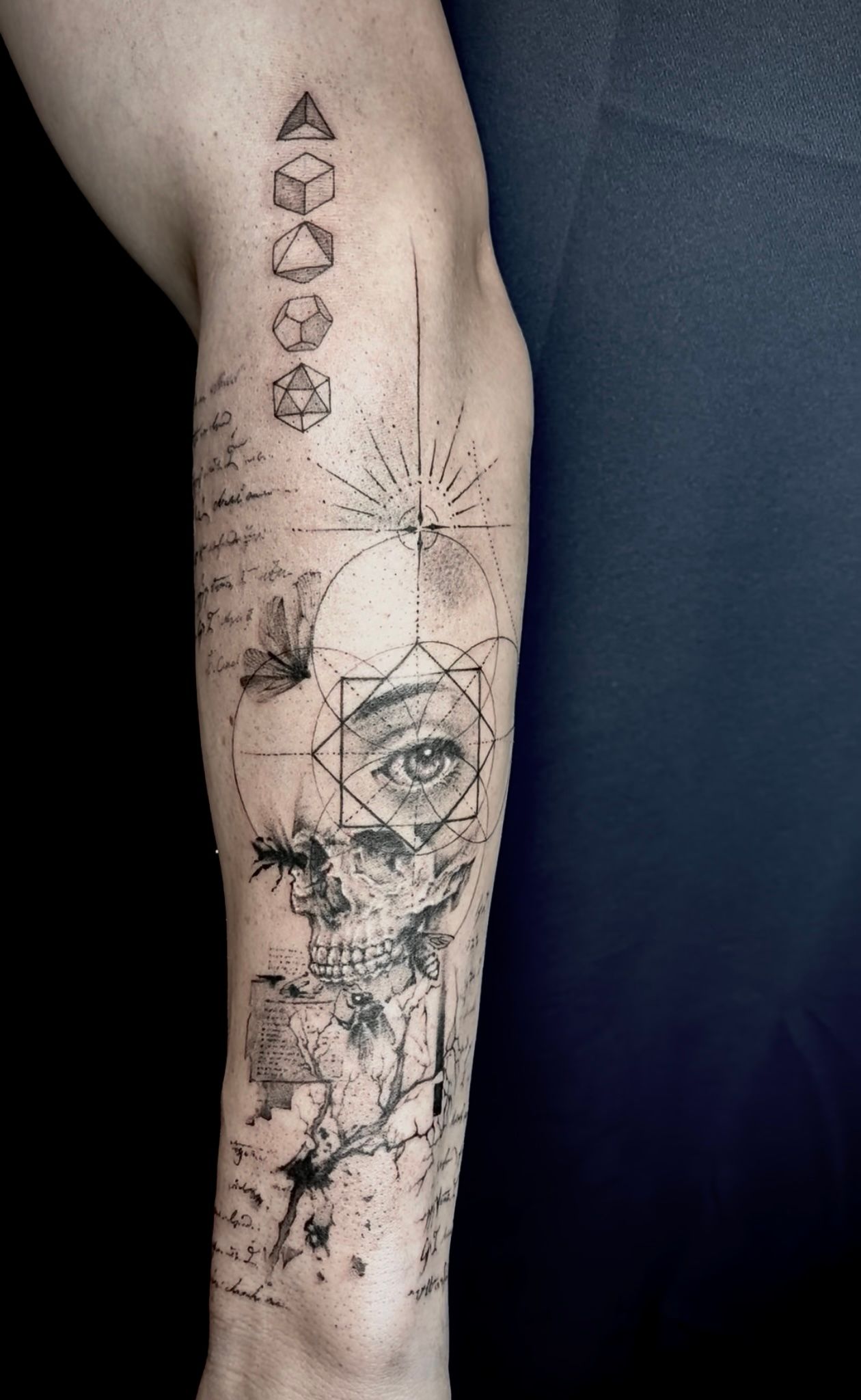 Fine-line geometric tattoo with stacked polyhedra and radiating linework