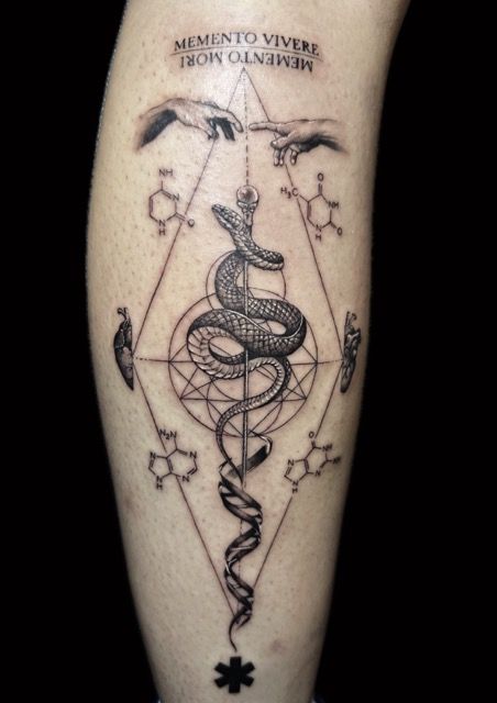 Tattoo of serpent around a staff, framed by geometric shapes, with text
