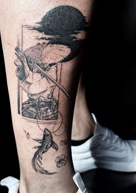 Tattoo of a samurai, koi fish, and moon on leg. Black and white, with some shading.