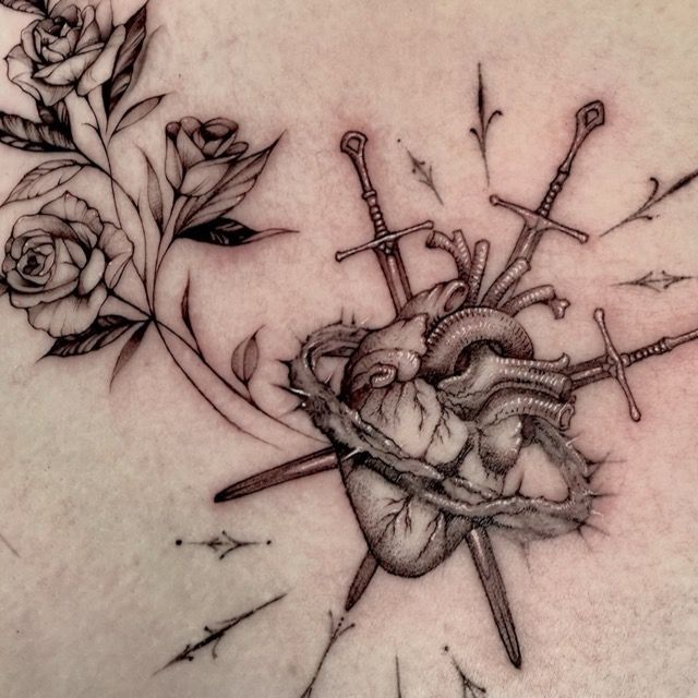 Black and gray roses, anatomical heart and crossed swords tattoo