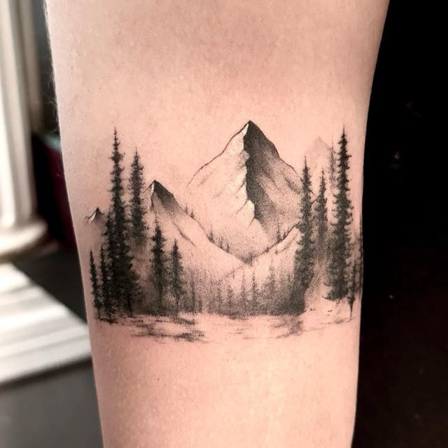 Black and gray mountain and pine forest tattoo