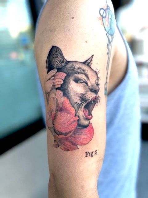 Color realism roaring cat and flower tattoo on the upper arm