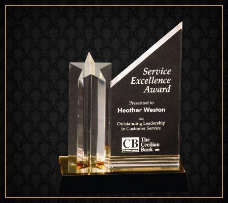 A service excellence award is presented to heather weston