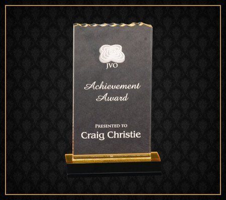 A plaque that says achievement award on it