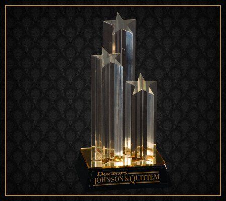 A trophy that says doctors johnson & quiitem on it