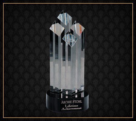 A crystal trophy that says lifetime achievement on it