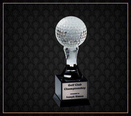 A golf club championship trophy with a golf ball on top
