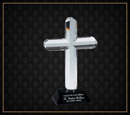 A clear crystal cross on a black base