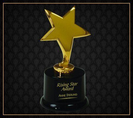 A rising star award with a gold star on top