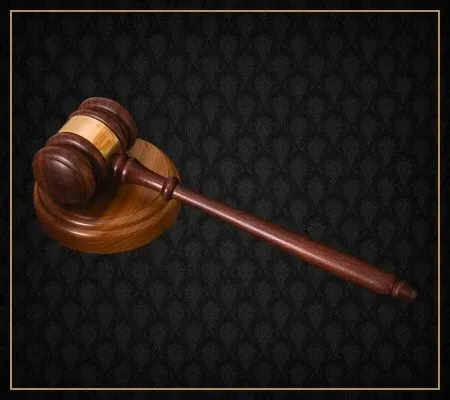 A wooden judge 's gavel on a black background