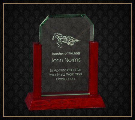A plaque that says teacher of the year john norms