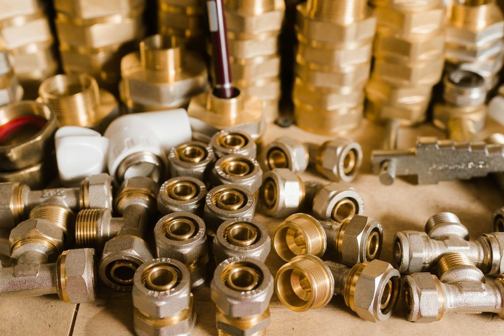 Pile of Brass and Metal Plumbing Fittings, Various Shapes and Sizes — D & E Milner Plumbing In The Palms, QLD
