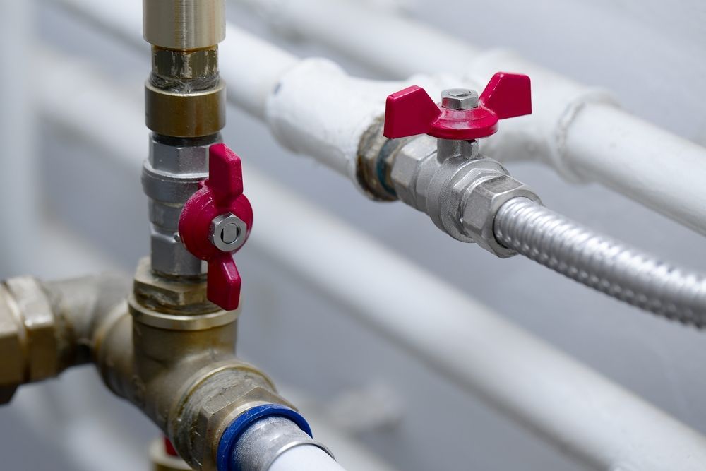 Close-up of Plumbing Pipes With Two Red-handled Valves — D & E Milner Plumbing In The Palms, QLD