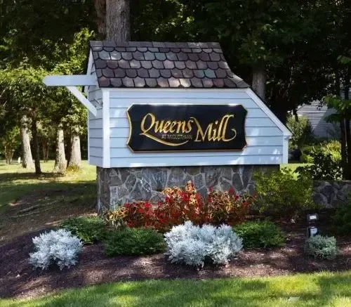 A sign that says queens mill on it