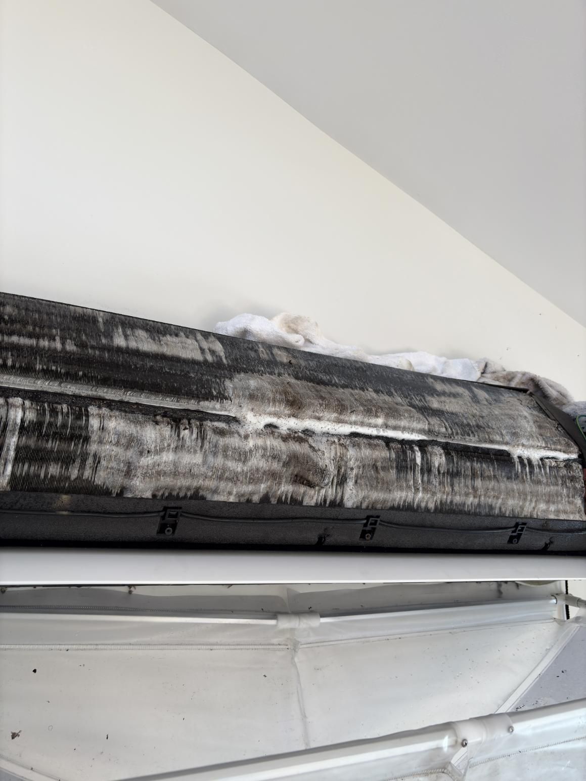 A Dirty Air Conditioner Is Hanging from The Ceiling — Staub Air in Garbutt, QLD