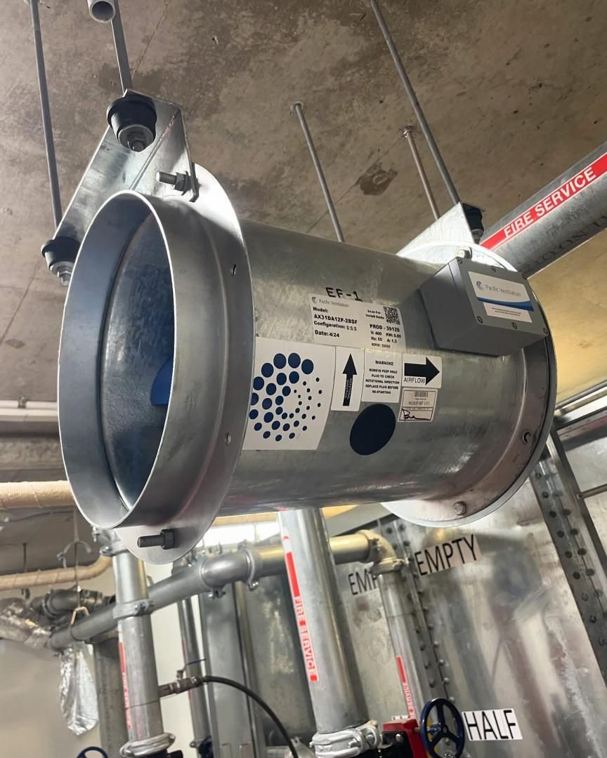 A Large Metal Pipe Is Hanging from The Ceiling in A Room — Staub Air in Garbutt, QLD