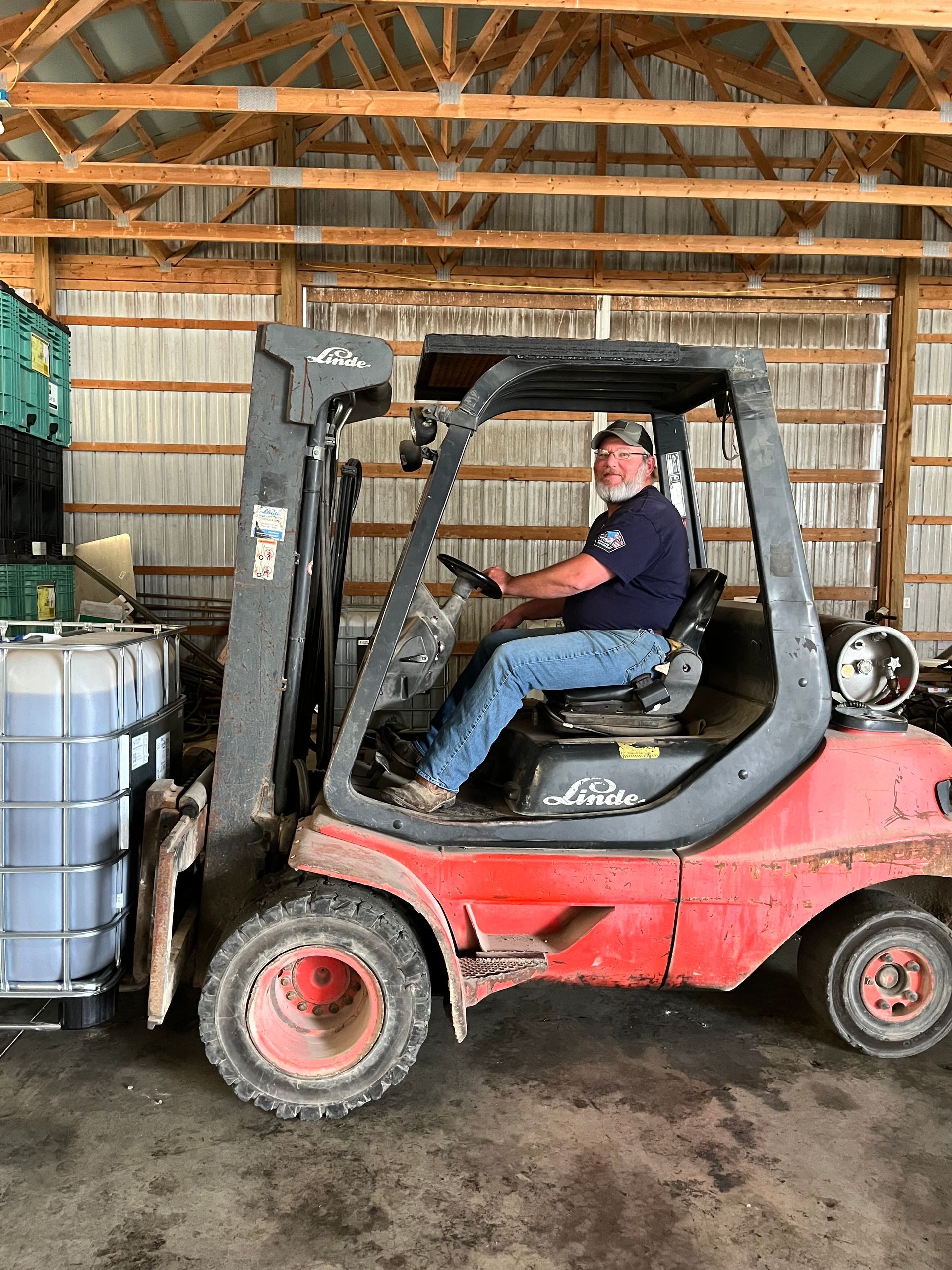 Expert loading farm supply containers with a forklift.