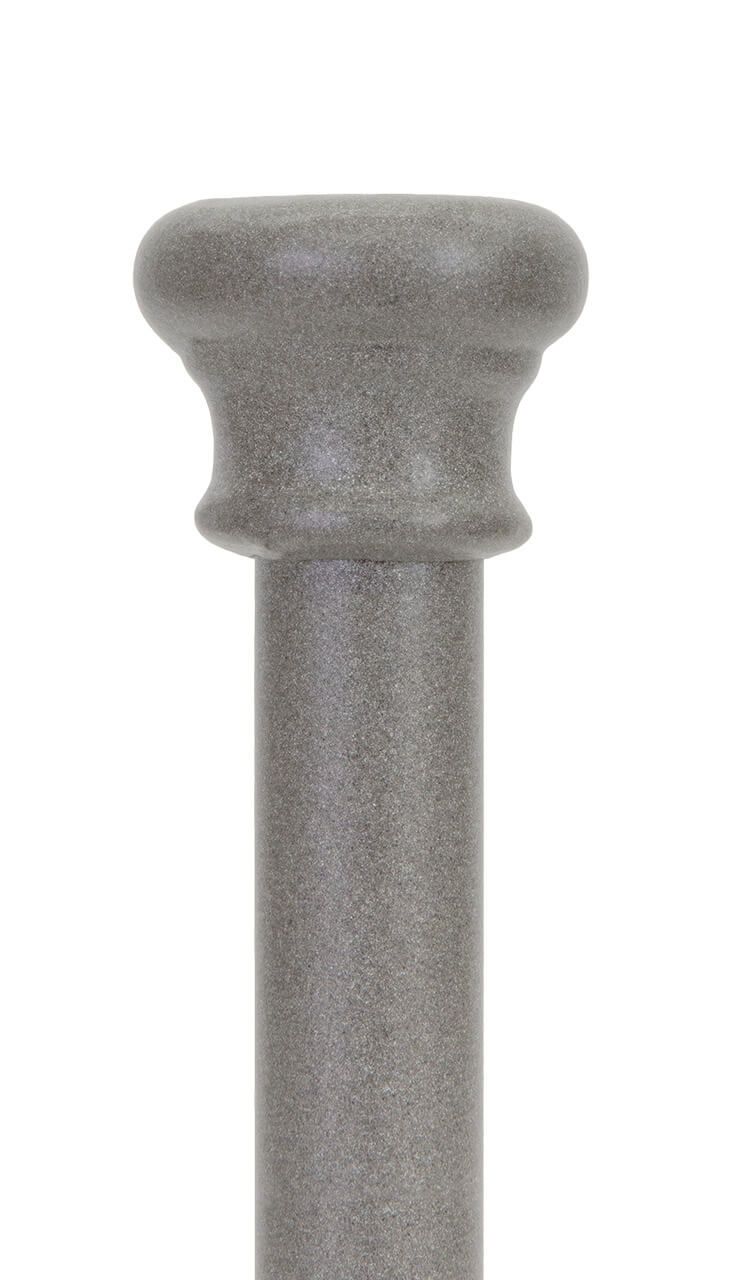 A close up of a gray pole on a white background.