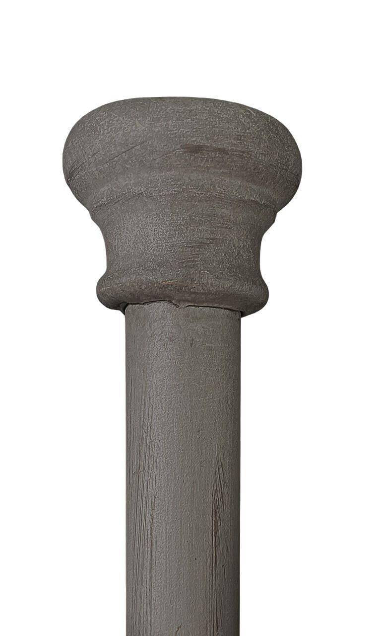A close up of a gray pole with a round top on a white background.