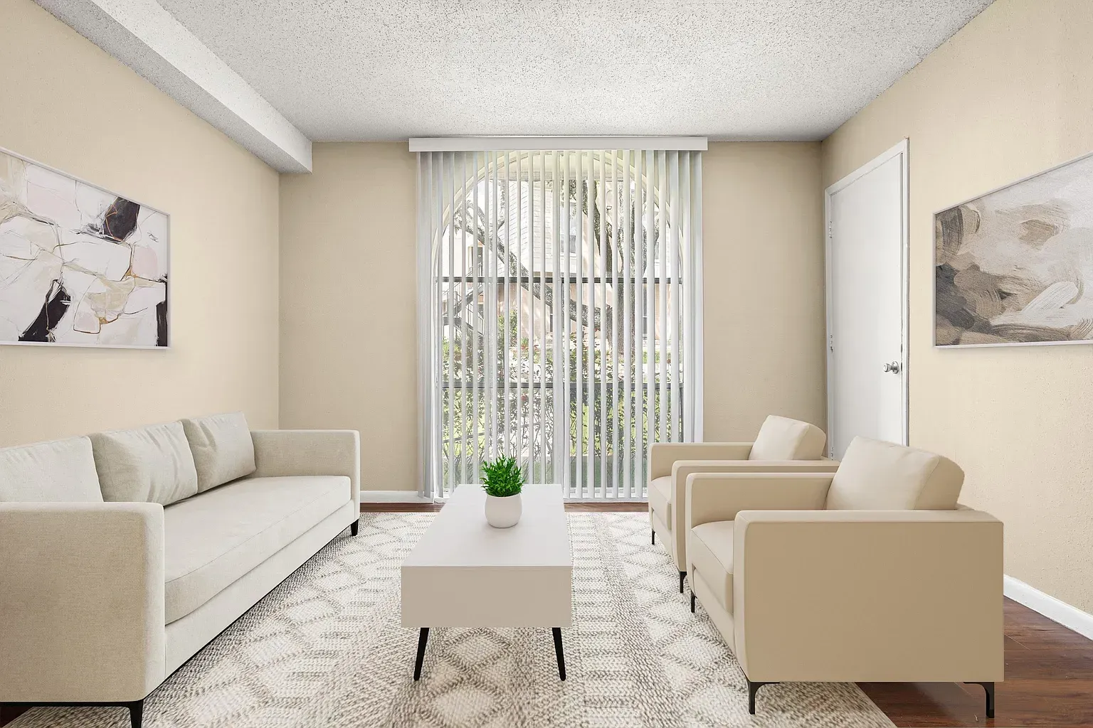 Living room in a beige apartment with a cream sofa, two chairs, a white coffee table, and vertical blinds.