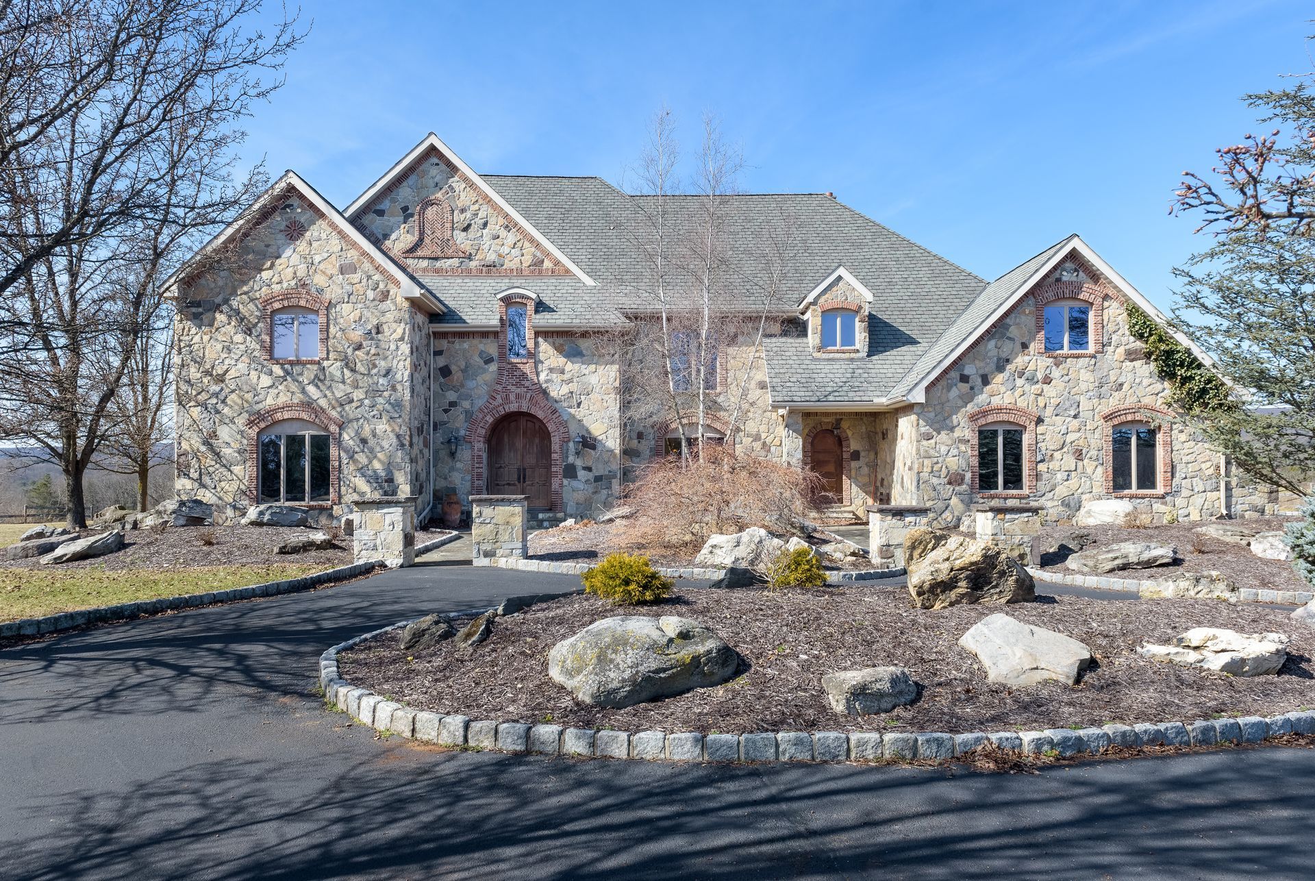 A large stone house with a slate roof is for sale.