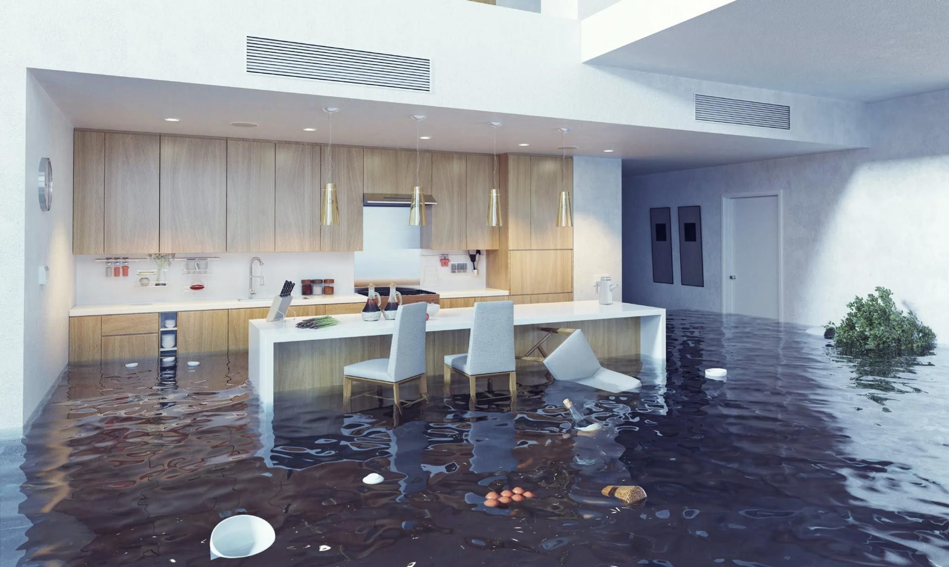 A kitchen and dining room are flooded with water.