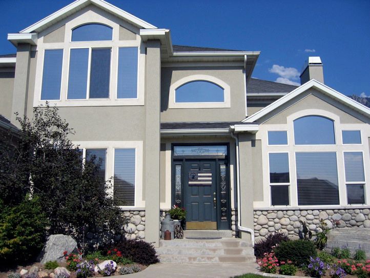 A large house with lots of windows and a black door