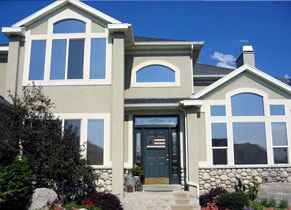 A large house with a lot of windows and a black door