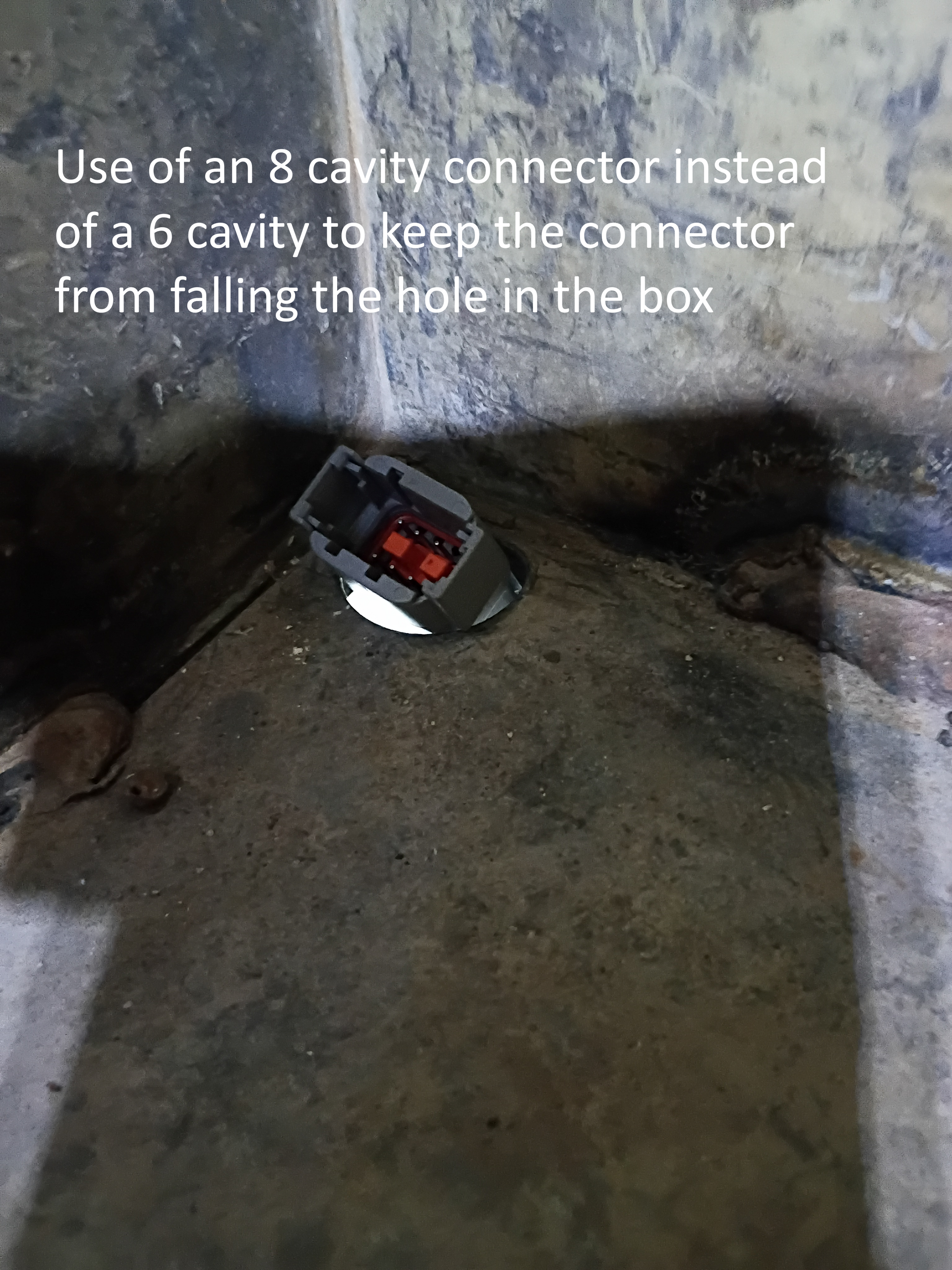 Small black-and-red tool wedged in a concrete corner beside overlaid instructional text.