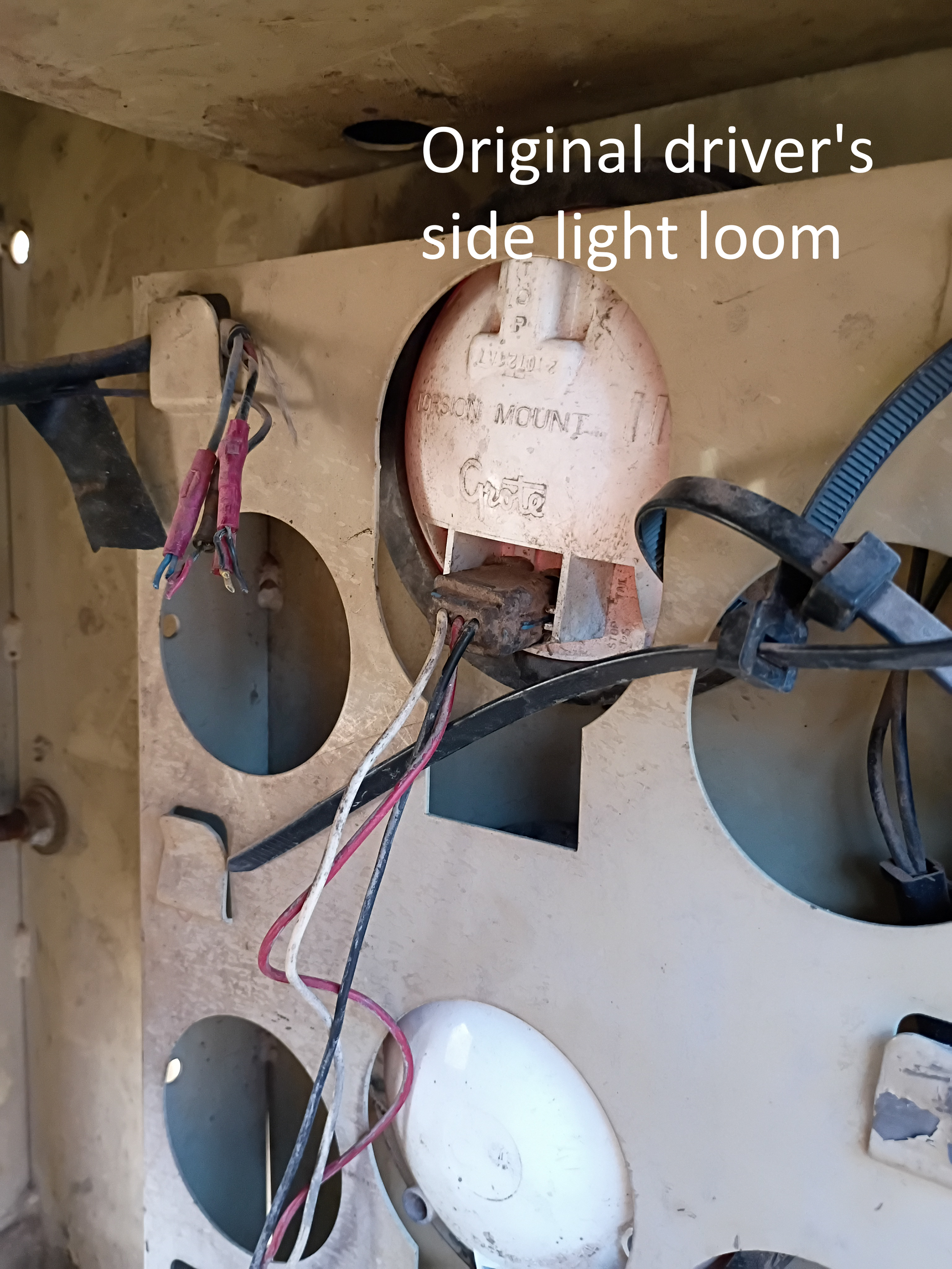 Dashboard wiring with labeled original driver’s side light loom and circular cutouts