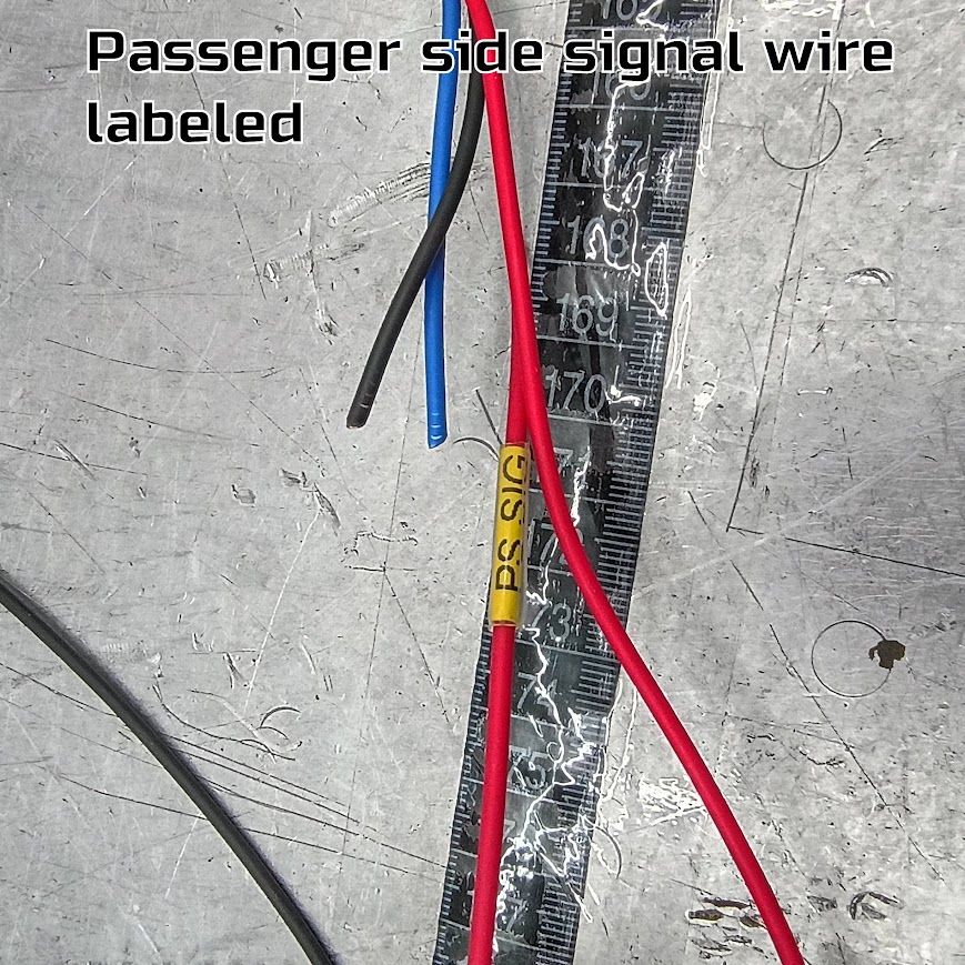 Passenger side signal wire labeled, with red, black, and blue wires on a gray surface