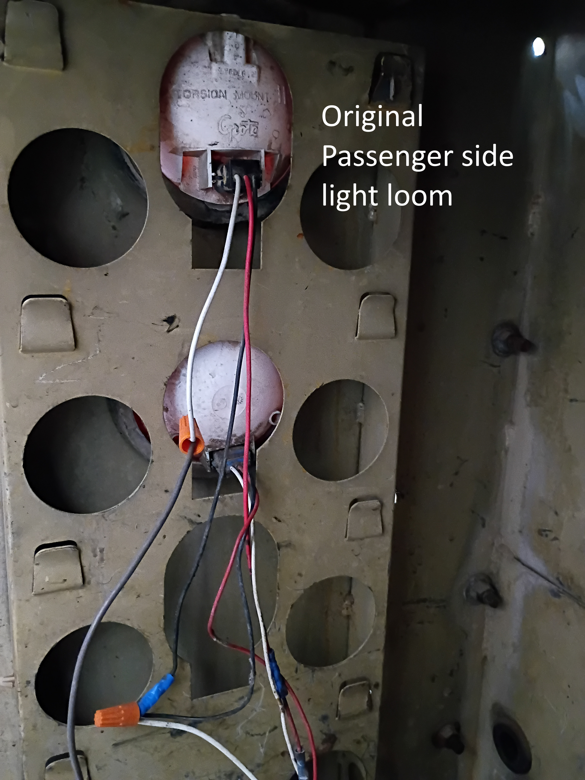 Electrical panel interior with labeled passenger-side light loom and visible red and white wires.