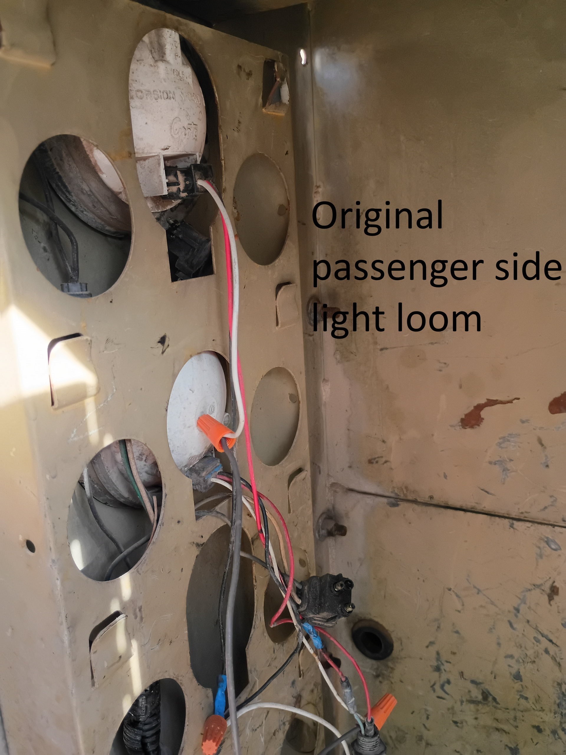 Interior of an aircraft panel with exposed wiring, labeled “Original passenger side light loom.”