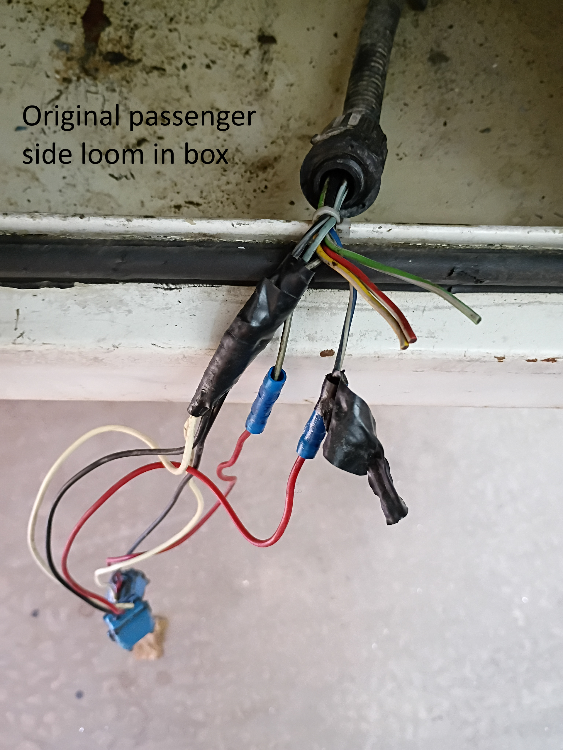 Cut wires and connectors hanging from a car door loom, with handwritten label visible.